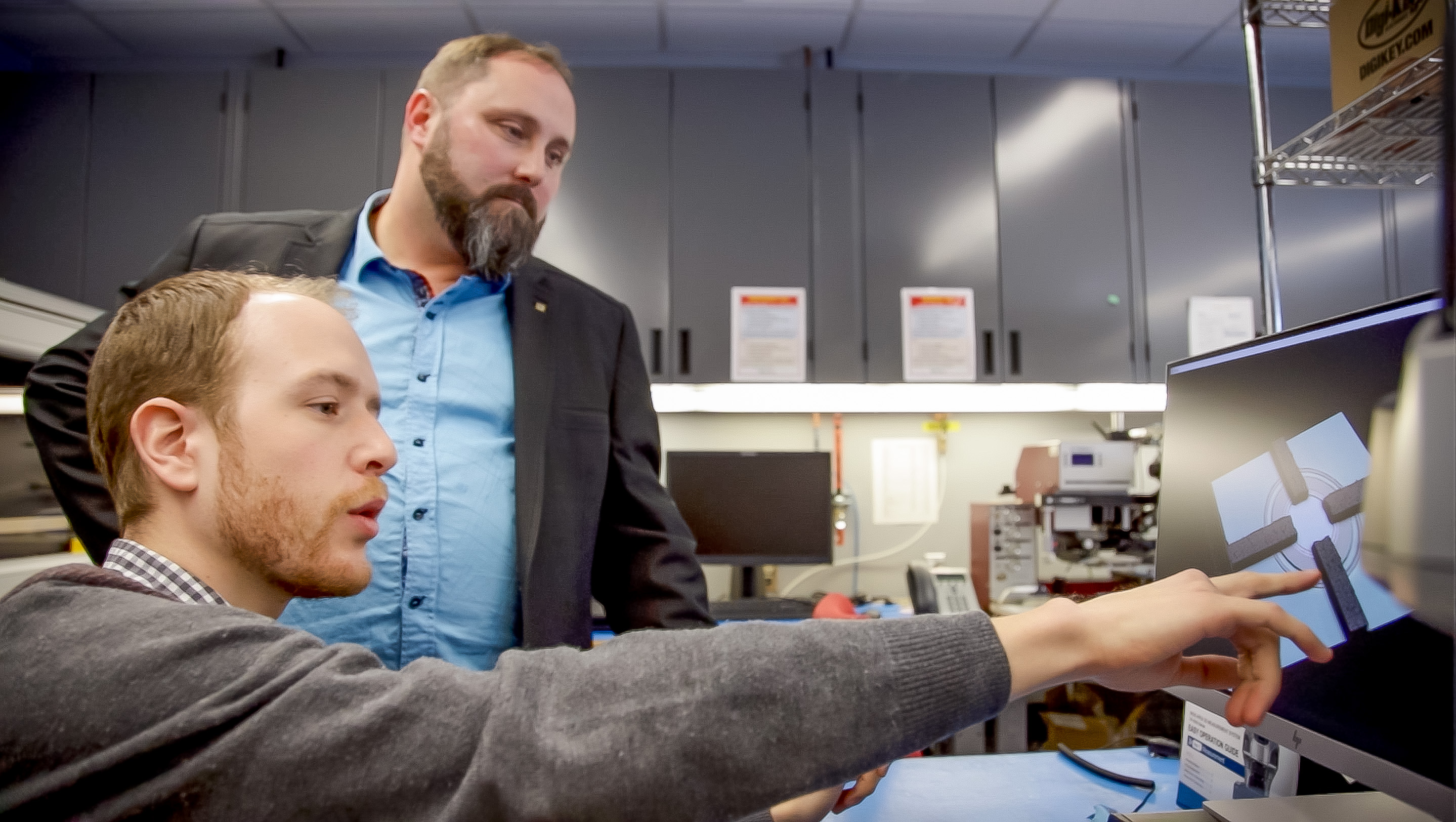 Jean-François Pratte and Frédéric Vachon, foreground, working in a laboratory