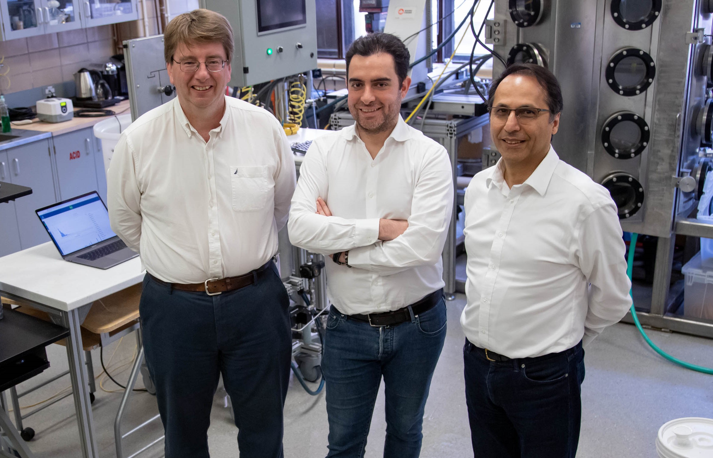 Dr. Pierre Sullivan, with Dr. Amirreza Amighi and Dr. Nasser Ashgriz standing in front of lab equipment