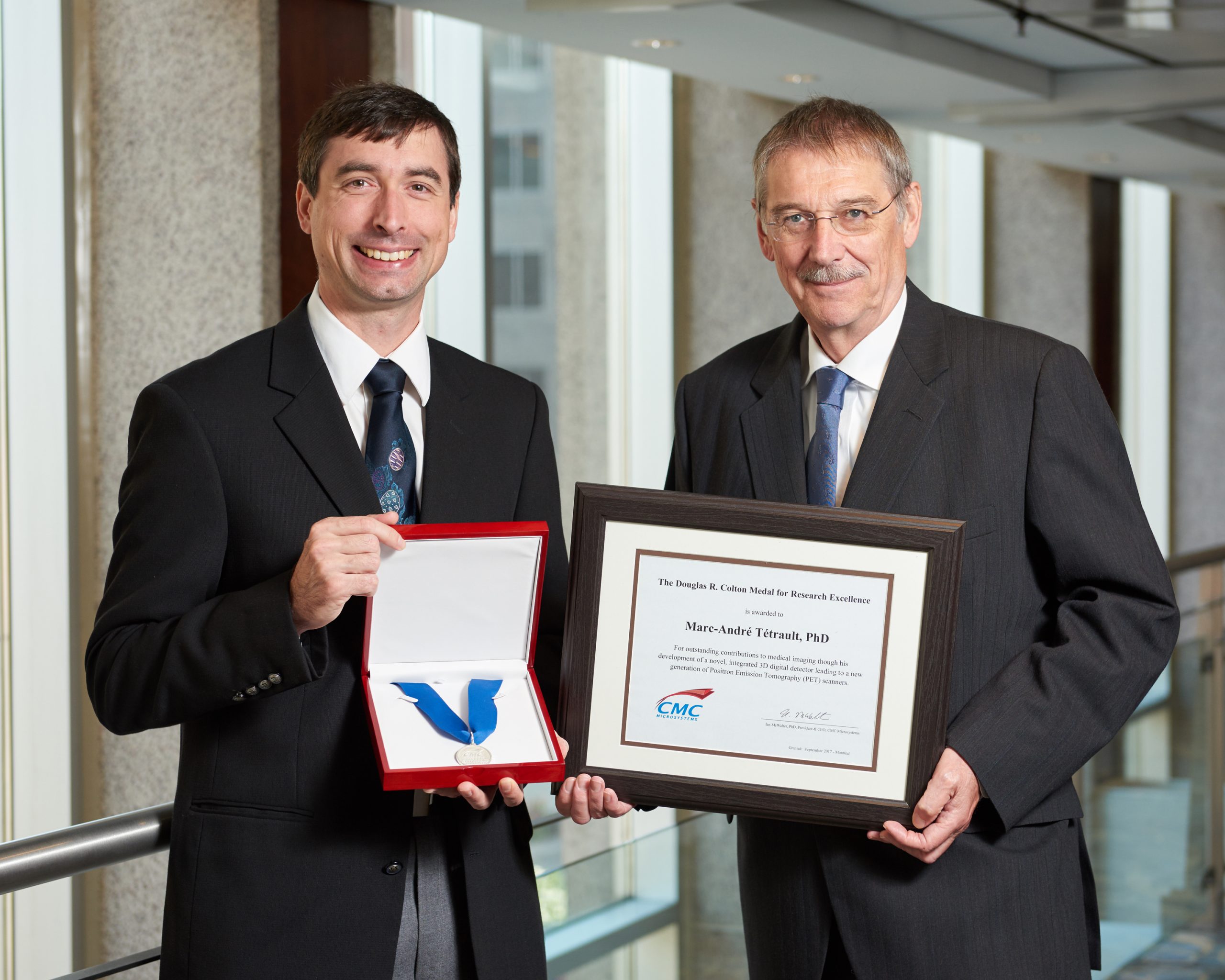 Dr. Marc-André Tétrault & Dr. Ian McWalter holding Colton certificate and medal