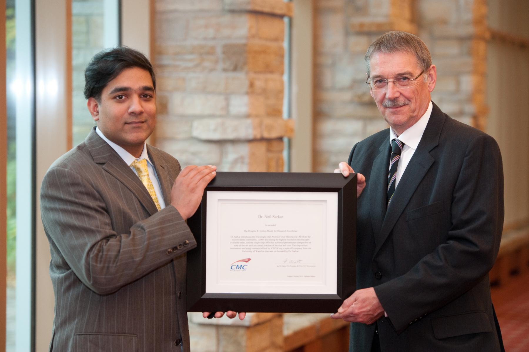 Dr. Neil Sarkar & Dr. Ian McWalter holding Colton certificate
