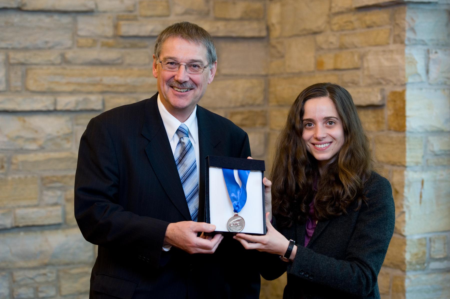 Dr. Ian McWalter & Dr. Leyla Soleymani holding Colton medal