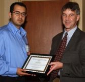 Behraad Bahreyni accepts his award from Chris Lumb.