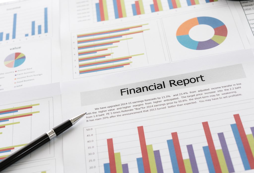 Financial graphs and charts report with pen on desk of business advisor. financial and accounting report concepts.